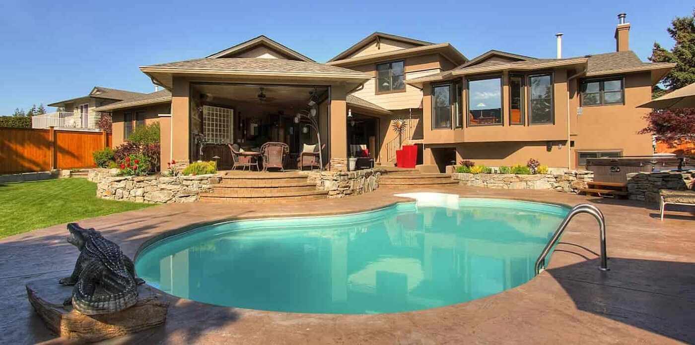 Backyard interlocking paver patio with pool